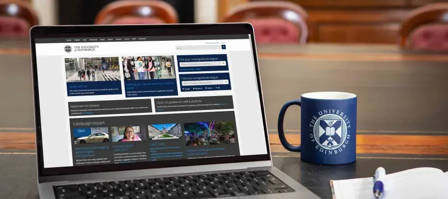 laptop with Edinburgh University website open and cup