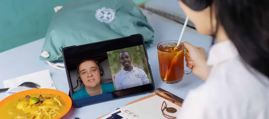 online lecture with two men on a zoom call and a woman watching 