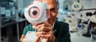 Professor Baljean Dhillon with model eye. Photo by Andrew Perry.