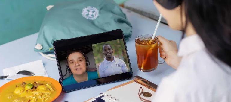 online lecture with two men on a zoom call and a woman watching 