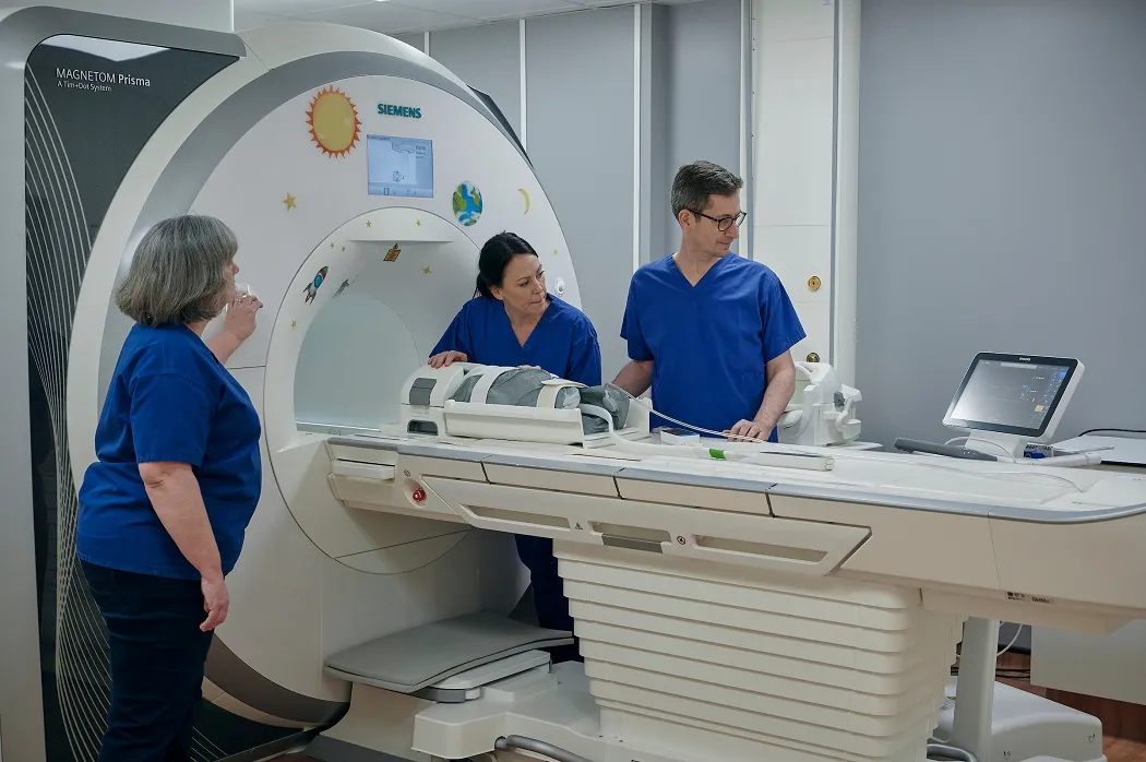 The Edinburgh Imaging Facility RIE MR scanner, with Edinburgh Imaging radiographer (left) and TEBC study team members, Professor James Boardman (right) and Dr Gemma Sullivan (middle). Images courtesy of Maverick Photo Agency.