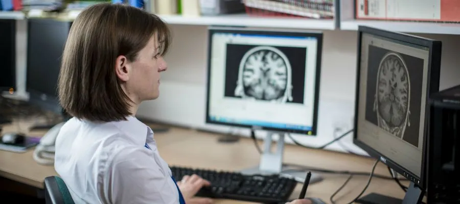 Woman looking at a brain on a screen
