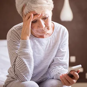 woman looks at phone worriedly