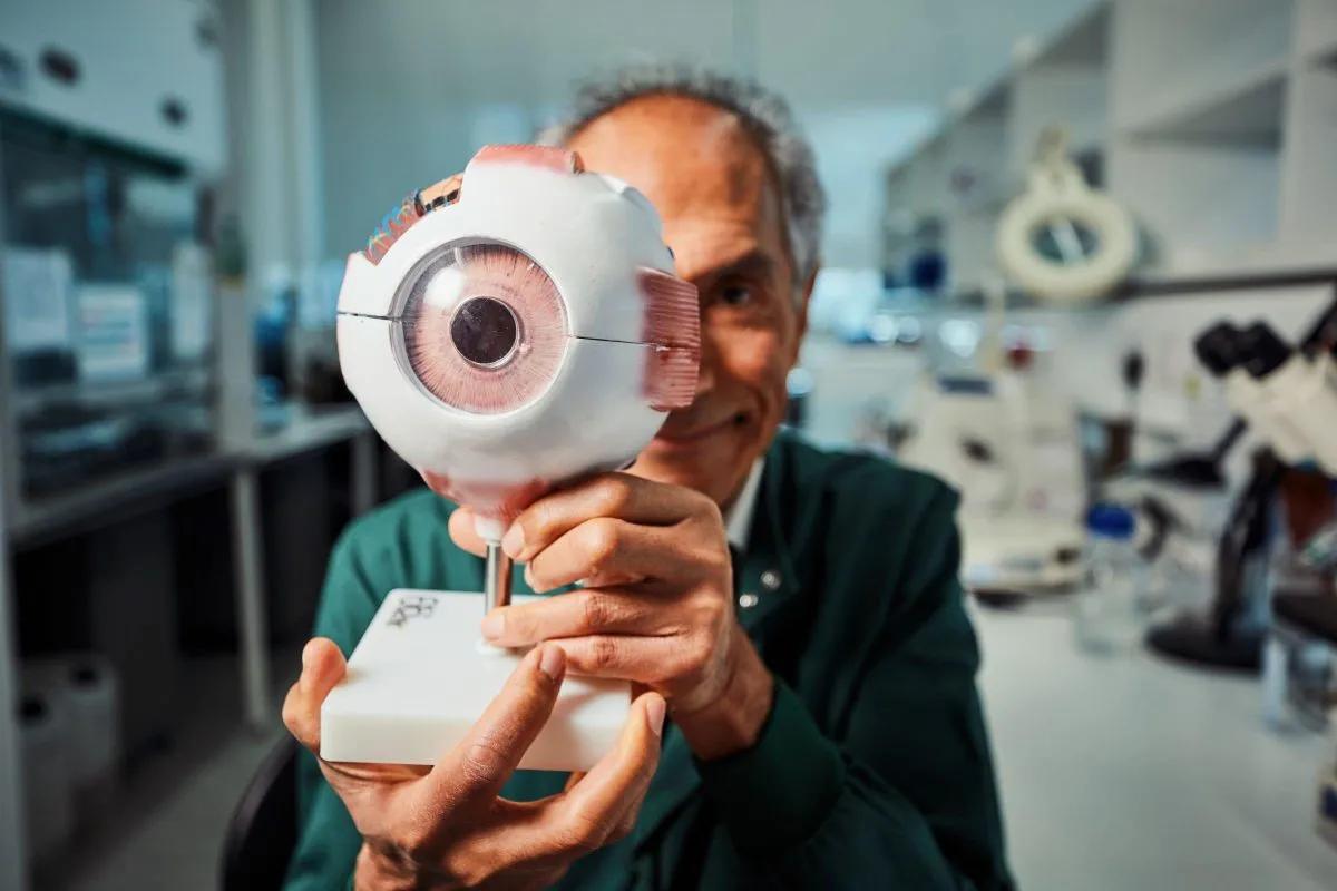 Professor Baljean Dhillon with model eye. Photo by Andrew Perry.