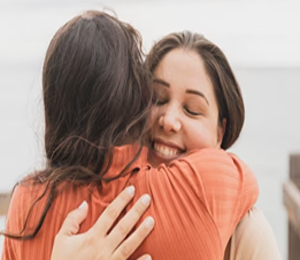 two girls embrace